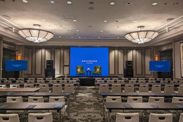 Conference room at Rosewood London with stage, screens and guest seating
